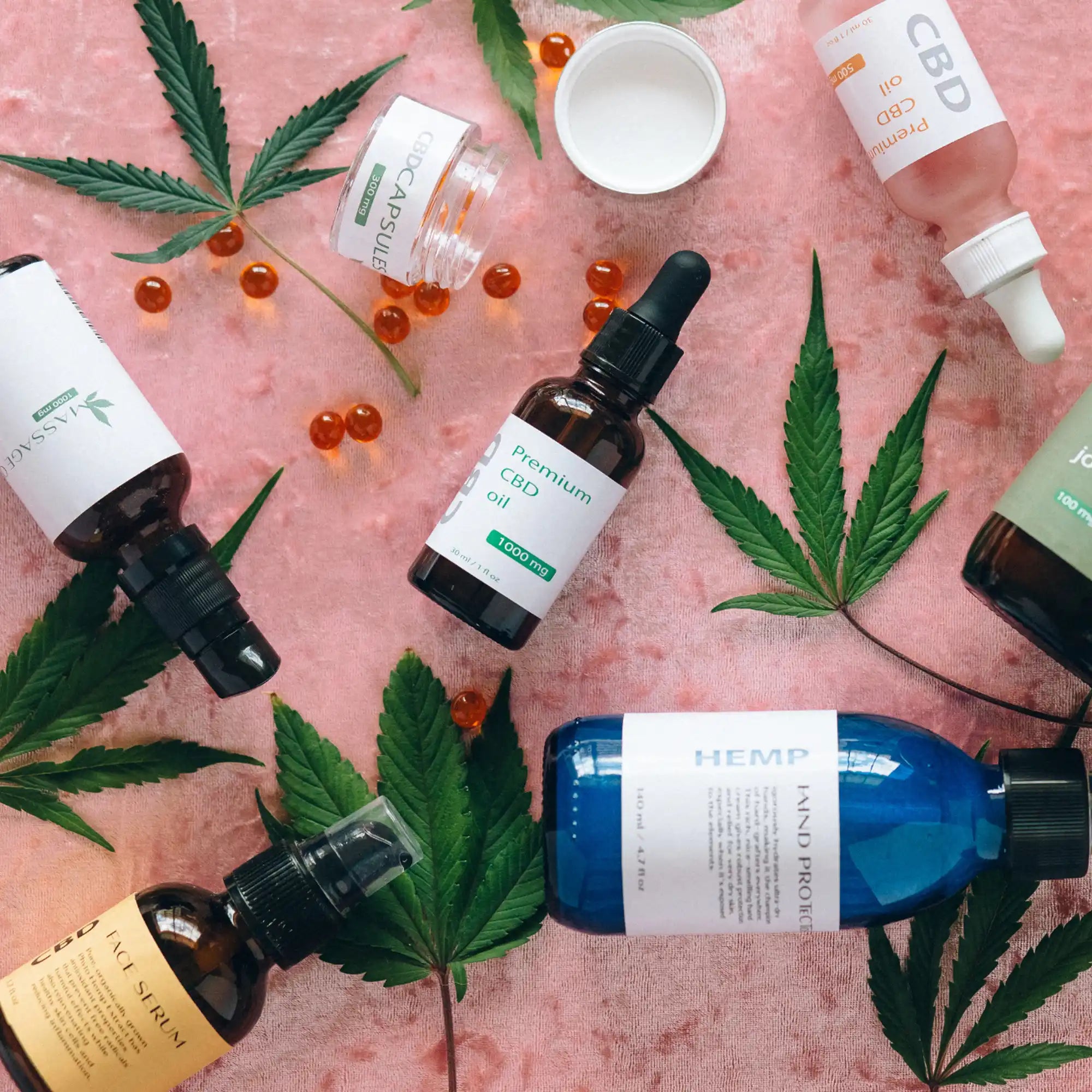 Collection of CBD and cannabis-related products including oils, capsules, and cannabis leaves.